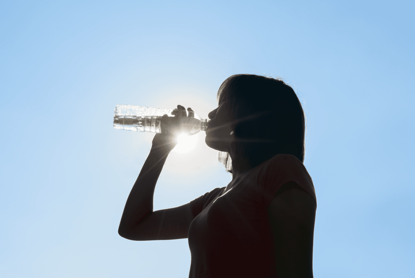 woman drinking water in the summer sun